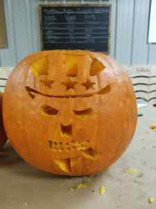 Pumpkin carved with Deplorable Logo at Axe Play Hudson NH