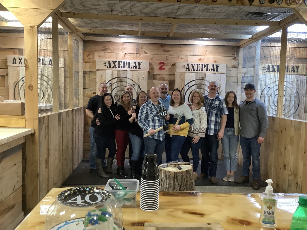 Friends enjoying a birthday party with axe throwing at Axe Play in Hudson NH