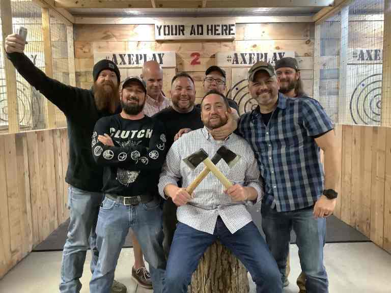 Bachelor party group posing in axe throwing lane Hudson NH