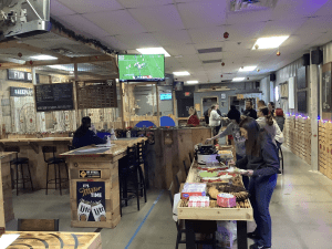 Guests enjoying bring-your-own-food in the lounge at Axe Play Hudson NH.