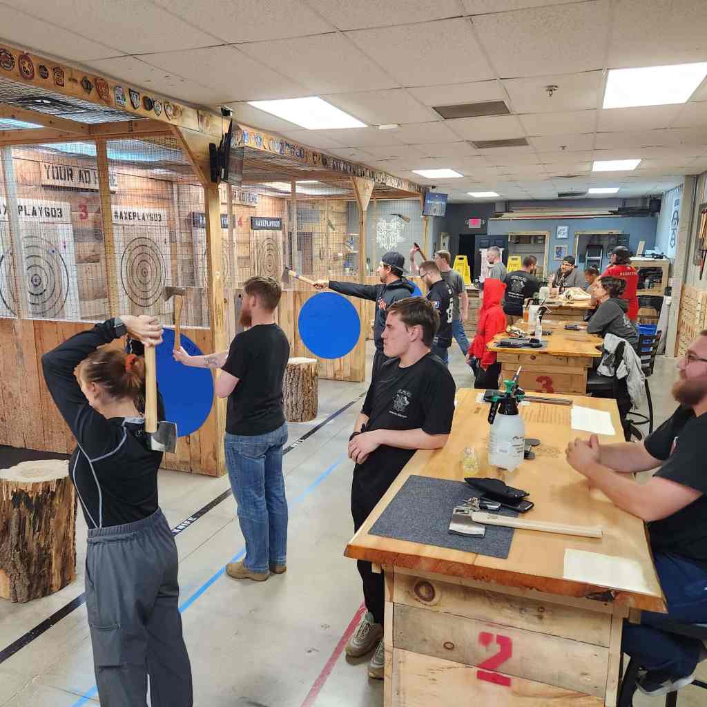 Axe Play league night action with players throwing in Hudson NH