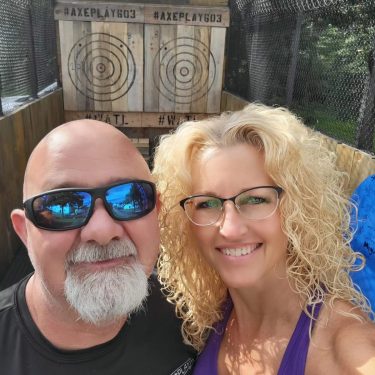 Matt and Maria from Axe Play holding each others axes