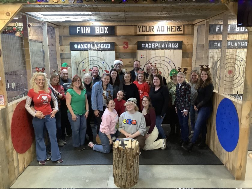Large group celebrating holiday party with axe throwing at Axe Play Hudson NH