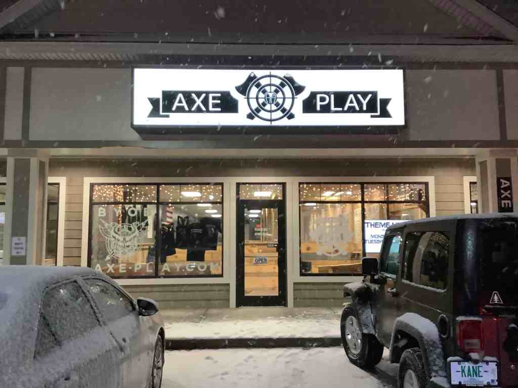 Axe Play axe throwing venue in Hudson NH during winter snowfall at night