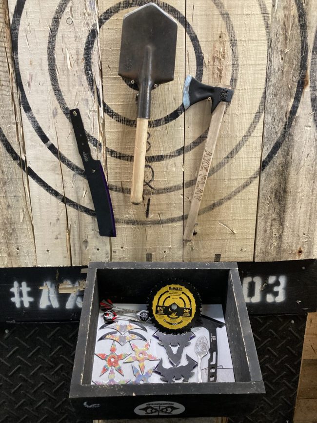 Fun Box throwables at Axe Play including saw blade, throwing stars and novelty items for returning guests