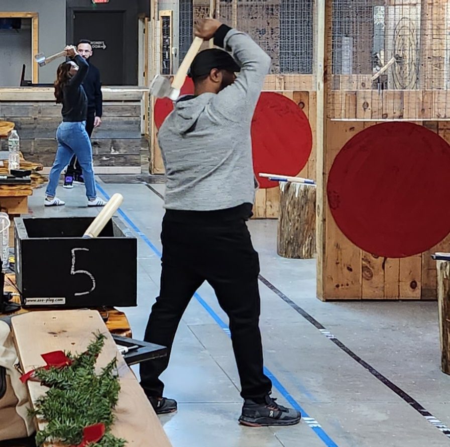 Axe throwing overhead setup position showing proper form before release