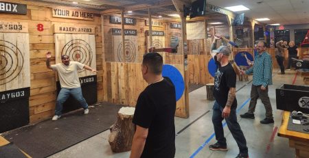 Friends enjoying axe throwing in Hudson NH near Nashua and Lowell at Axe Play