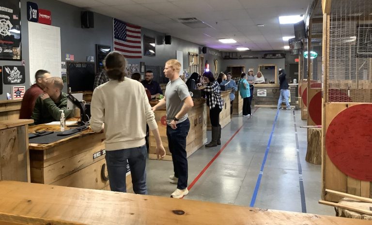 Guests enjoying axe throwing across multiple lanes at Axe Play.