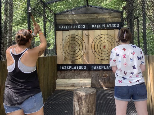 Women axe throwing at a graduation party in New Hampshire during a mobile event