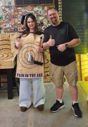 Participant of different age group in axe throwing challenge at Axe Play NH