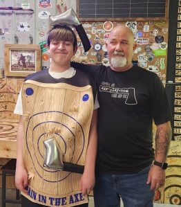 Customer smiling after axe throwing challenge at Axe Play NH