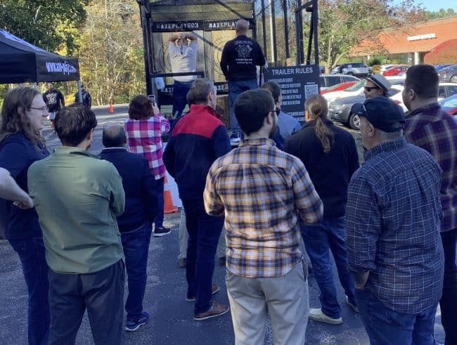 corporate team building activity nh employees watching axe throwing competition
