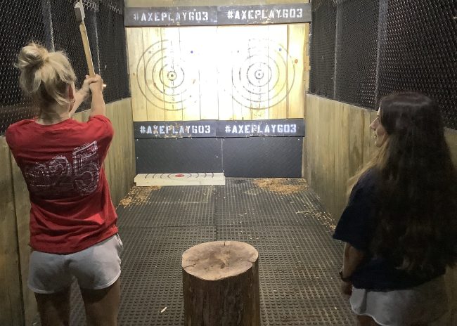 Graduation party axe throwing in New Hampshire with participant wearing class of 2025 shirt