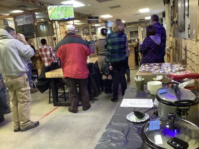 Guests enjoying food and conversation during a company holiday party at Axe Play.